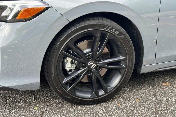 Close-up of a tire mounted on a black Honda wheel